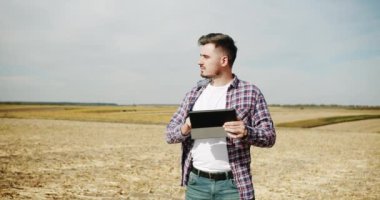 Business agriculture harvesting concept. quality control green sorghum farm. green wheat crop germ agriculture industry. Farmer with digital tablet checking on Field of grain sorghum.