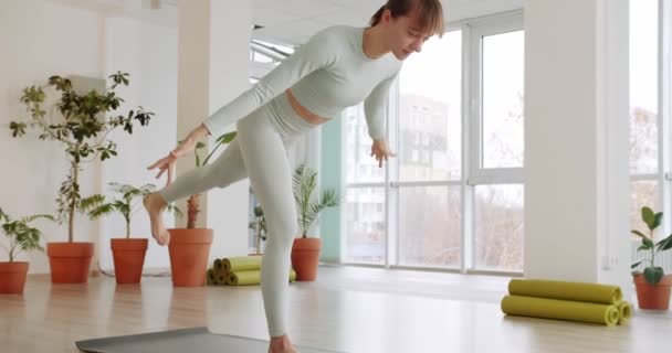 Beautiful Woman Practices Position Yoga Warrior Bright Studio Virabhadrasana Healthy — Wideo stockowe