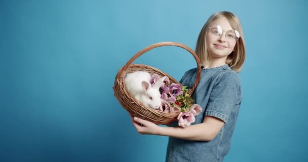 Tonårstjejen Blå Klänning Håller Korg Med Kanin Handen Isolerad Blå — Stockvideo