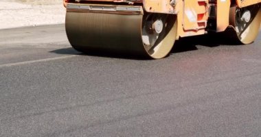 Asphalt paver machine on a road construction site. Road Paving on Residential Street. Road building asphalt paver is laying a new layer of asphalt, Asphalt Road Construction