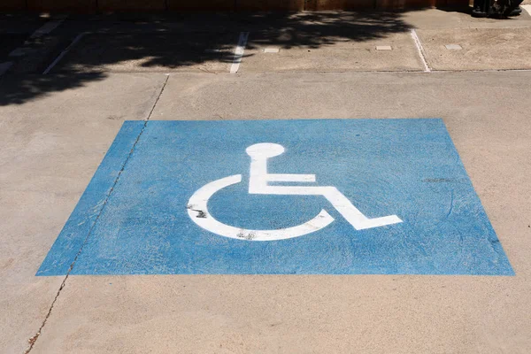 Reserved parking space for handicapped person in a parking lot.