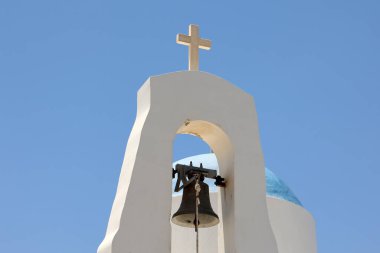 Bell tower with a cross on a church in Cyprus.