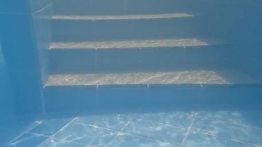 Tiled underwater stairs in the pool.
