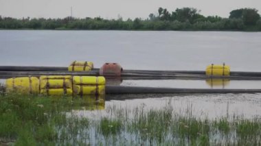Pumping sand on the river. Water pump and pipes on the water