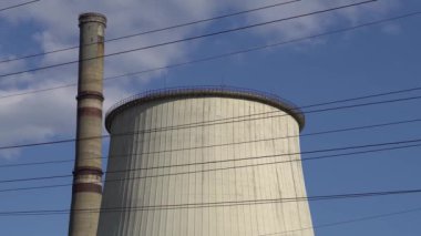 Thermal power plant. CHP chimney against the blue sky.