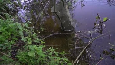 Net for catching fish on the background of water. Fishing, recreation on the river