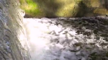 Old dam on the river. Close-up footage of the waterfall.