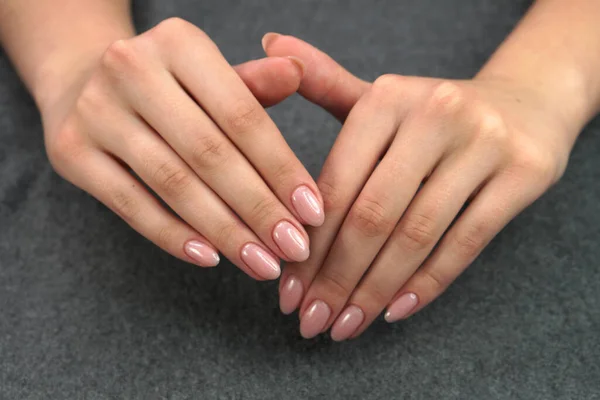 Women\'s hands after manicure and gel polish. Cosmetology procedure and skin care in a beauty salon.