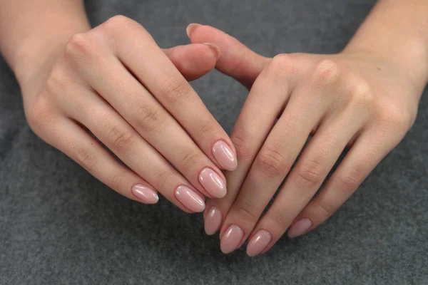 Women's hands after manicure and gel polish. Cosmetology procedure and skin care in a beauty salon.