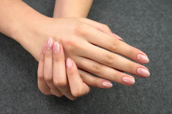 Women\'s hands after manicure and gel polish. Cosmetology procedure and skin care in a beauty salon.