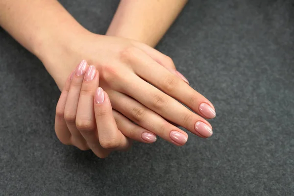 Women\'s hands after manicure and gel polish. Cosmetology procedure and skin care in a beauty salon.