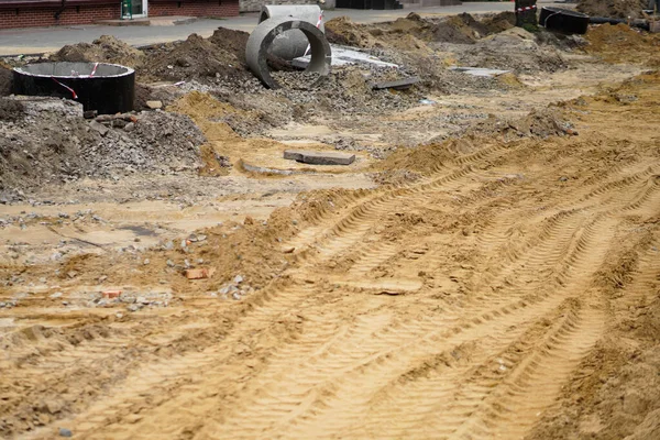 Tire track on yellow sand. Construction, repair of the street, roads.