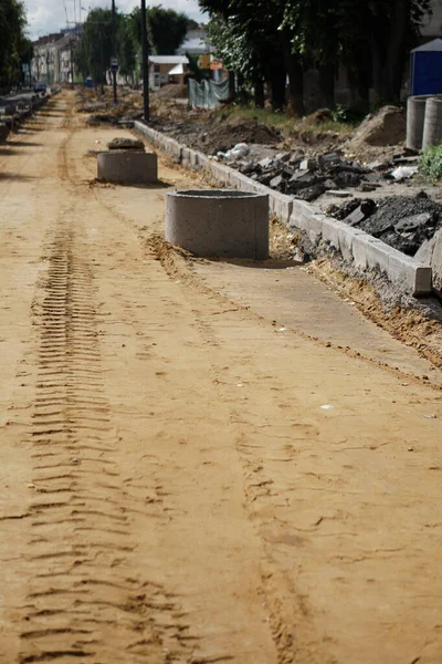 Tire track on yellow sand. Construction, repair of the street, roads.