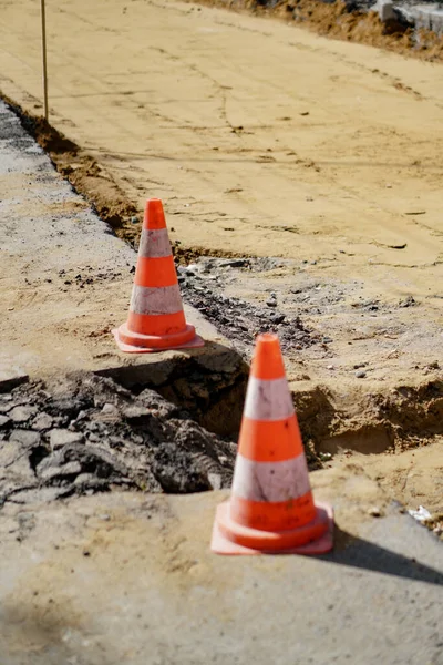 Road cone. Construction and repair of the road on the street. Precaution sign.