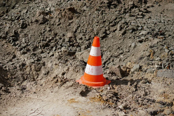 Road cone. Construction and repair of the road on the street. Precaution sign.