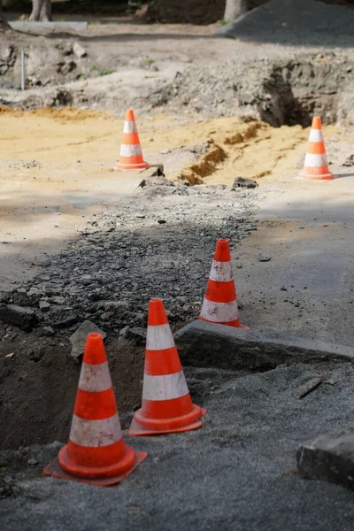 Road cone. Construction and repair of the road on the street. Precaution sign.