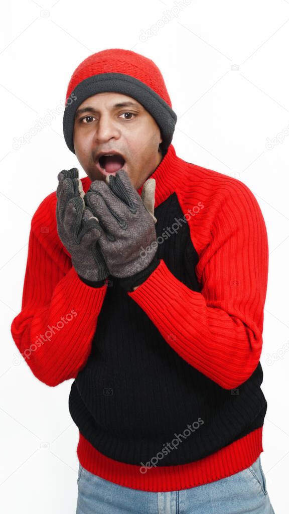 Young Indian Man Wearing a Woolen Sweater, Hand Gloves and Cap, Winter Season, Red and Black Sweater and Cap, Grey Hand Gloves, isolated in White Background, Warm Clothes, Filling Coldness