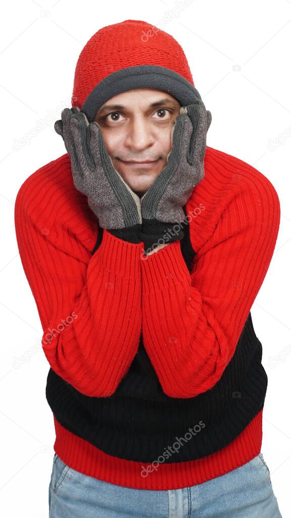 Young Indian Man Wearing a Woolen Sweater, Hand Gloves and Cap, Winter Season, Red and Black Sweater and Cap, Grey Hand Gloves, isolated in White Background, Warm Clothes, Hand On Face