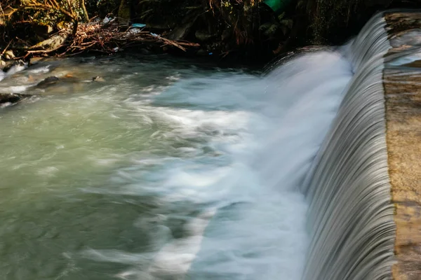 Long exposure photography High volume water runoff flows river with strong flow
