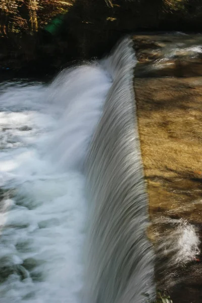 Long exposure photography High volume water runoff flows river with strong flow