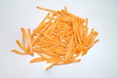 vegan carrot sticks in a pile top view, isolated on white backgroun