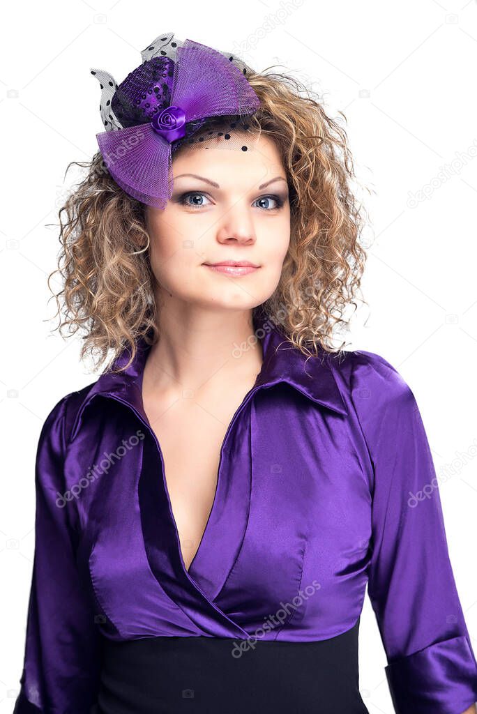 Bautiful woman with curly hair and decorative violet hat and violet dress, shoulder portarait, isolated on white background. Glance of a confident woman.