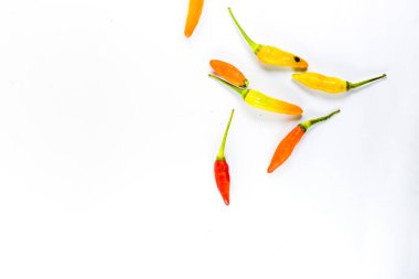 Farklı renklerde kırmızı biber çeşitleri izole edilmiş beyaz arka planda şekiller oluşturur..