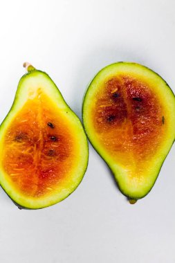 a mini watermelon that looks like an avocado on an isolated white background.