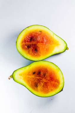 small red watermelon with black seeds on an isolated white background.