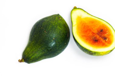 Mini watermelon is cut in half on an isolated white background. one inside and one leather