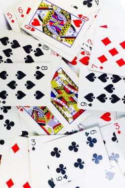 a deck of randomly scattered poker cards on an isolated white background. 