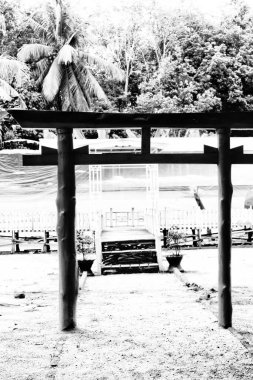 the gate of the mountain god temple with a natural view of nature.  high contrast black and white