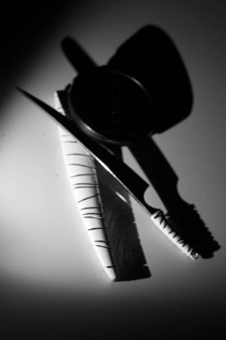 small knife and scabbard in the dark. black and white photography. copy space for war, kingdom, knight, power and attack.