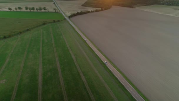 Aerial Drone Shot Car Driving Highway View Fields Either Side — Stock Video