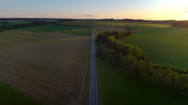 Luchtdrone Birds Eye View European Countryside Road Sunset Wind Turbines — Stockvideo