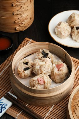 Bambu buharı ve baharatlı sosta servis edilen çeşitli malzemeli Dimsum. Seçici odak resmi. Kapat..