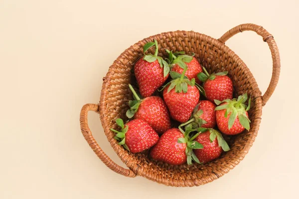 stock image Strawberry, Fresh juicy strawberries with leaves served in rattan basket. Close up and selective focus.