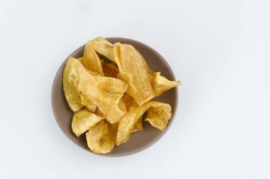 Beyaz arka planda bir yığın kurutulmuş muz cipsi. Seçici odak resmi, bulanık arkaplan.