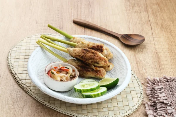 Sate Lilit, traditional Balinese minced chicken satay with lemongrass as skewer, served with sambal matah.