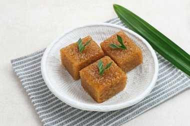 Wajik, geleneksel Endonezya aperatifi buharda pişmiş pirinç, palmiye şekeri, hindistan cevizi sütü ve pandan yapraklarından yapılır..