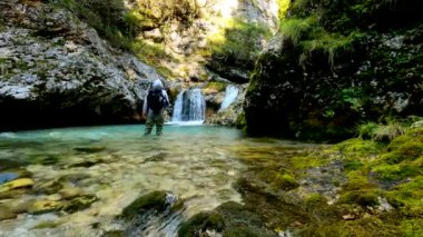 Filmmaker in Action on a Torrent with Canyon of the Dolomites - 5K