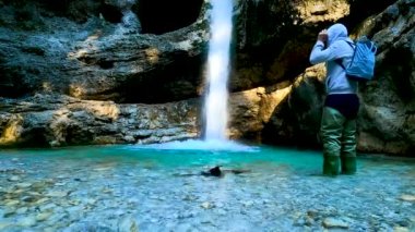  Filmmaker in Exploration in a River with Canyon and Waterfalls - 5K
