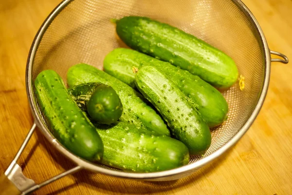 Groep Komkommers Een Zeef Het Aanrecht — Stockfoto