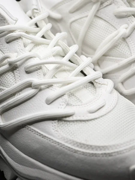 closeup isolated shot of white running shoes with white laces and nice stitching