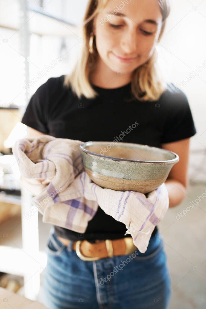 Shot of a young ceramic artist working in her pottery workshop