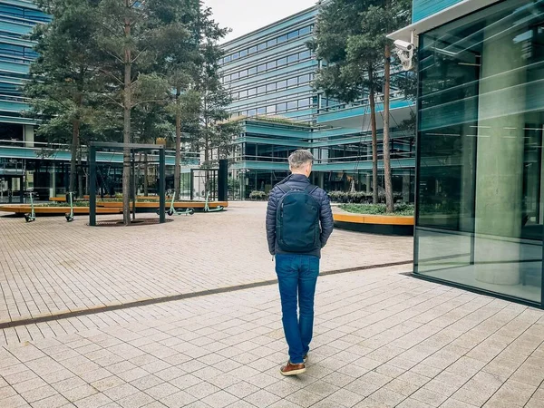 A man goes to work in a modern quarter.