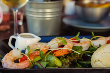 Shrimp salad on a table in a restaurant close-up. Healthy food.