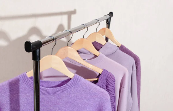 Closeup of fashionable tops in trendy purple, very peri, lavender colors on a shopping rail. — 图库照片