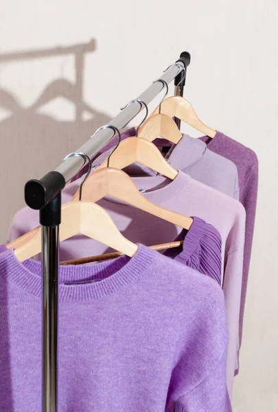 화려 한 보라색, 화려 한 라벤더 색으로 쇼핑용 레일 위에 걸려 있는 유행하는 최고의 옷들. — 스톡 사진