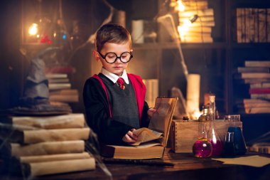  Small wizard reads magic book Cosplay Harry Potter. Halloween holiday. Halloween costume party  clipart